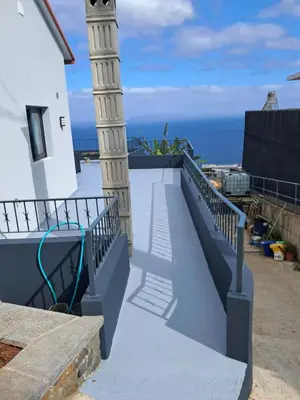 a balcony of a building with the ocean in the background at House Virginia in Santa Cruz