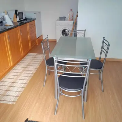 a kitchen with a table and chairs in a room at House Virginia in Santa Cruz