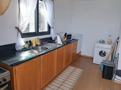 a kitchen with a sink and a washing machine at House Virginia in Santa Cruz