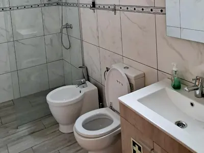 a bathroom with a toilet and a sink at House Virginia in Santa Cruz