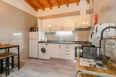 a kitchen with a washer and dryer in it at Cantinho da Deolinda in Luz