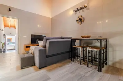 a living room with a couch and a table at Cantinho da Deolinda in Luz
