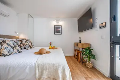 a bedroom with a bed with a hat on it at The SPOT in Funchal