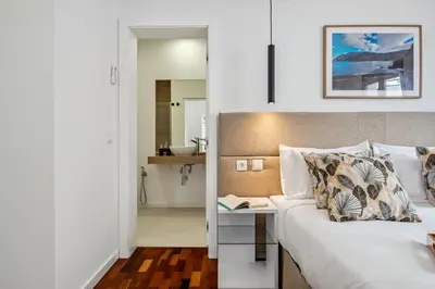 a bedroom with a bed and a table with a book at The SPOT in Funchal