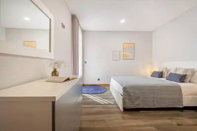 a bedroom with a bed and a desk at Casa das Raposinhas V, Funchal in Funchal