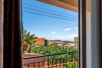 a view from a window of a balcony at Bright Modern 2BR Apartment Near Cristo Rei in Caniço