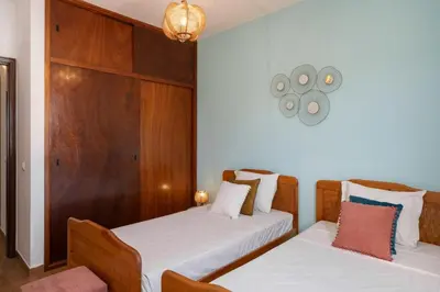two beds in a room with white sheets at Porto Santo Beach & Golf Apartment - Sun Refuge in Porto Santo