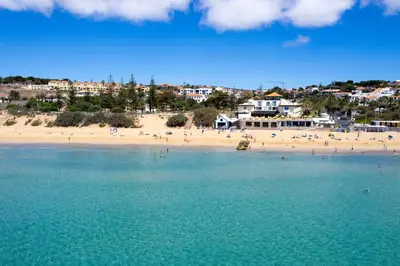 an aerial view of a beach with people in the water at Porto Santo Beach & Golf Apartment - Sun Refuge in Porto Santo