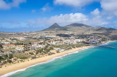 an aerial view of a beach with mountains in the background at Porto Santo Beach & Golf Apartment - Sun Refuge in Porto Santo