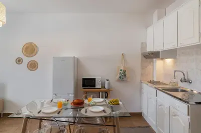 a kitchen with a glass table with food on it at Porto Santo Beach & Golf Apartment - Sun Refuge in Porto Santo