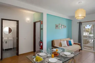 a living room with a couch and a table at Porto Santo Beach & Golf Apartment - Sun Refuge in Porto Santo