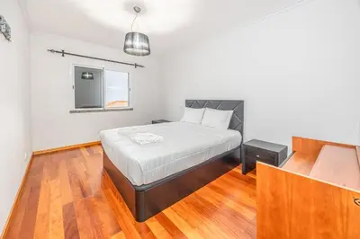 a bedroom with a bed and a window at Ti Clara in Caniço