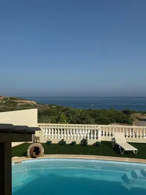 a swimming pool with a view of the ocean at Sea View Suite with Balcony and Pool - Praia da Luz in Luz