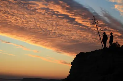 two people standing on top of a mountain at sunset at Sea View Suite with Balcony and Pool - Praia da Luz in Luz