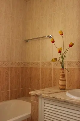 a bathroom with a vase with flowers on a counter at Sea View Suite with Balcony and Pool - Praia da Luz in Luz