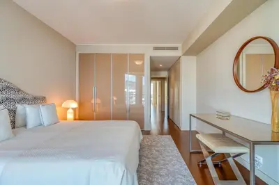 a bedroom with a bed and a desk and a mirror at Suite 107 in Funchal