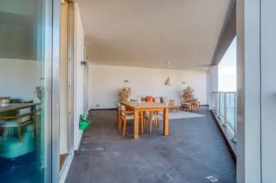 a dining room with a wooden table and chairs at Suite 107 in Funchal