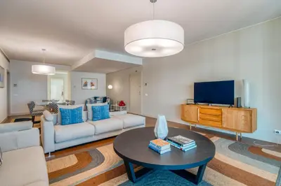 a living room with a couch and a tv at Suite 107 in Funchal