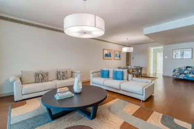 a living room with a couch and a table at Suite 107 in Funchal