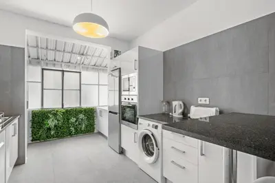 a kitchen with a washer and dryer in a room at Live, Love and Laugh in Funchal