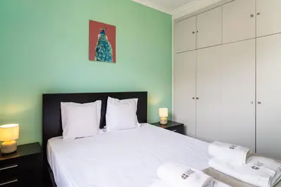 a bedroom with a large white bed with two towels at GuestReady - Caniço paradise with ocean view in Santa Cruz