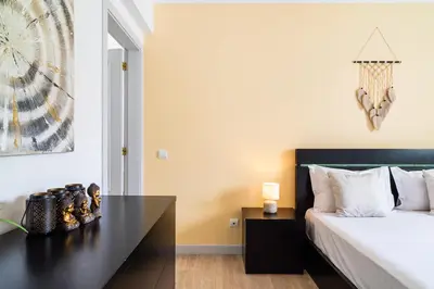 a bedroom with a bed and a black desk at GuestReady - Caniço paradise with ocean view in Santa Cruz
