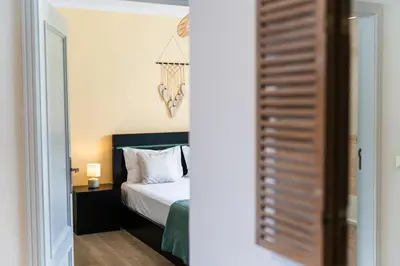 a bedroom with a bed and a room with a mirror at GuestReady - Caniço paradise with ocean view in Santa Cruz