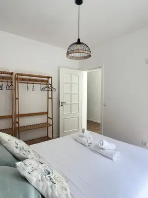 a bedroom with a bed with towels on it at Casa do Ribeirinho in Machico