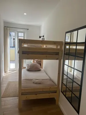 a bunk bed in a room with a window at Casa do Ribeirinho in Machico