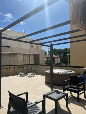 a patio with chairs and a hot tub on a building at Casa do Ribeirinho in Machico