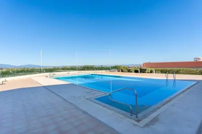 a large swimming pool with blue water at Casa Júlia, golfe piscina e praia in Lagos