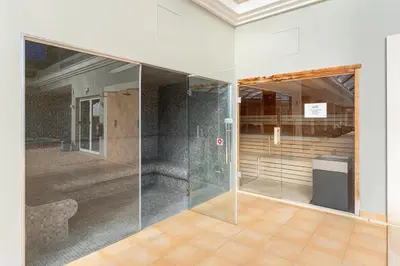 an empty room with a glass wall in a building at Casa Júlia, golfe piscina e praia in Lagos