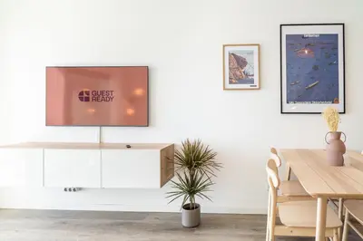 a dining room with a tv on a white wall at GuestReady - Endless Ocean Views in Santa Cruz