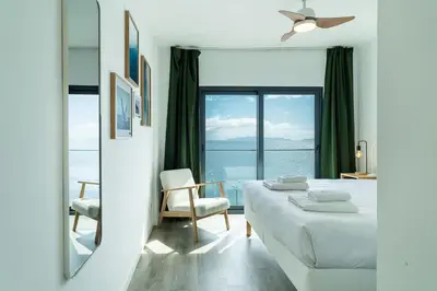 a white room with a bed and a mirror at GuestReady - Endless Ocean Views in Santa Cruz