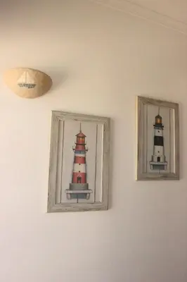 two framed pictures of two lighthouses on a wall at Sea View Suite with Pool - Praia da Luz in Luz