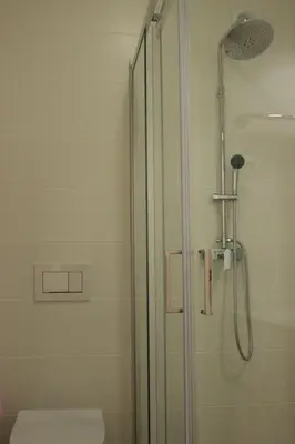 a bathroom with a glass shower with a toilet at Sea View Suite with Pool - Praia da Luz in Luz