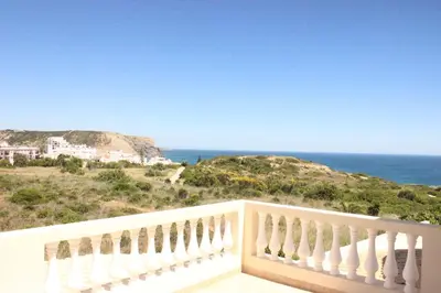 a balcony with a view of the ocean at Sea View Suite with Pool - Praia da Luz in Luz