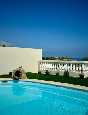 a swimming pool in front of a white building at Sea View Suite with Pool - Praia da Luz in Luz