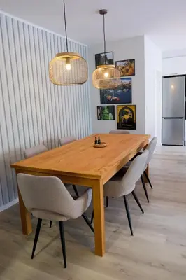 a wooden dining room table with chairs and two lights at New 3 Bedroom Luxury Family Apartment - Airco, King Size Beds, Fully equipped kitchen, Balcony, Washingmachine, 2 bathrooms, Free parking, Fast Internet, 142m2 in Machico