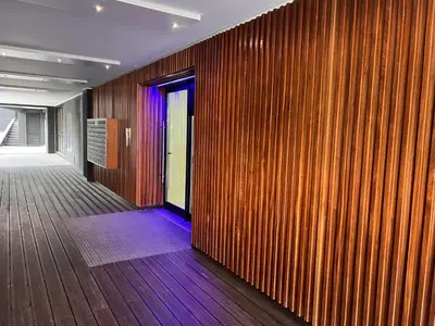a hallway with a wood paneled wall with purple lights at New 3 Bedroom Luxury Family Apartment - Airco, King Size Beds, Fully equipped kitchen, Balcony, Washingmachine, 2 bathrooms, Free parking, Fast Internet, 142m2 in Machico