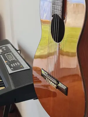 a guitar on a stand next to a laptop at Casa do Garajau 304 in Garajau