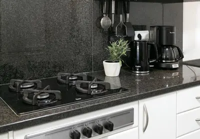 a kitchen counter with a stove top oven in a kitchen at Casa do Garajau 304 in Garajau