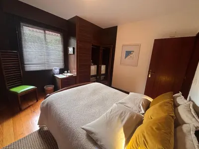 a bedroom with a large bed and a window at Suite Bela Vigia 4 in Jardim do Mar