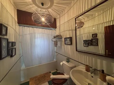 a bathroom with a sink and a toilet and a mirror at Suite Bela Vigia 4 in Jardim do Mar