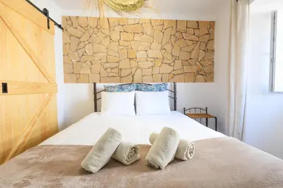 a bedroom with a bed with two pillows on it at Casinha da Raposeira in Raposeira