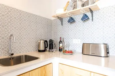 a kitchen with a sink and a counter top at Casinha da Raposeira in Raposeira