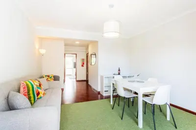 a living room with a couch and a table and chairs at JMF Apartment in Funchal