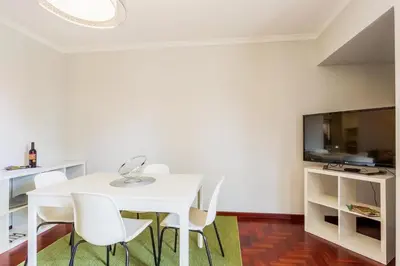 a white dining room with a white table and chairs at JMF Apartment in Funchal