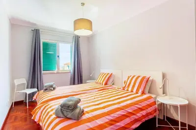 a bedroom with a bed with an elephant on it at JMF Apartment in Funchal