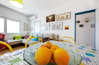 a kitchen and dining room with a table and chairs at Casa Dos Netos in Burgau